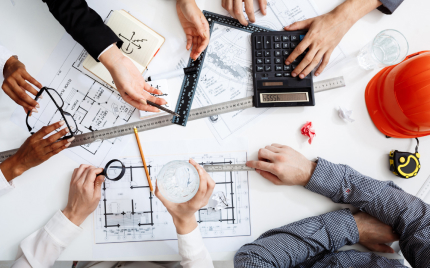 Commercial and finance leads reviewing construction plans